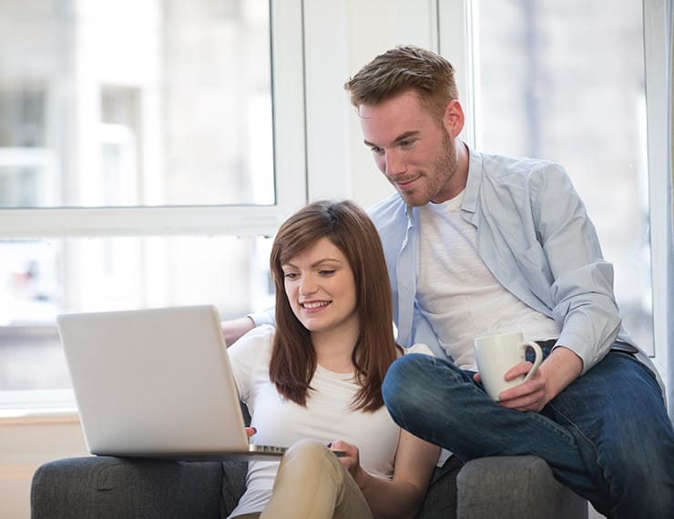 Couple looking at finances on laptop