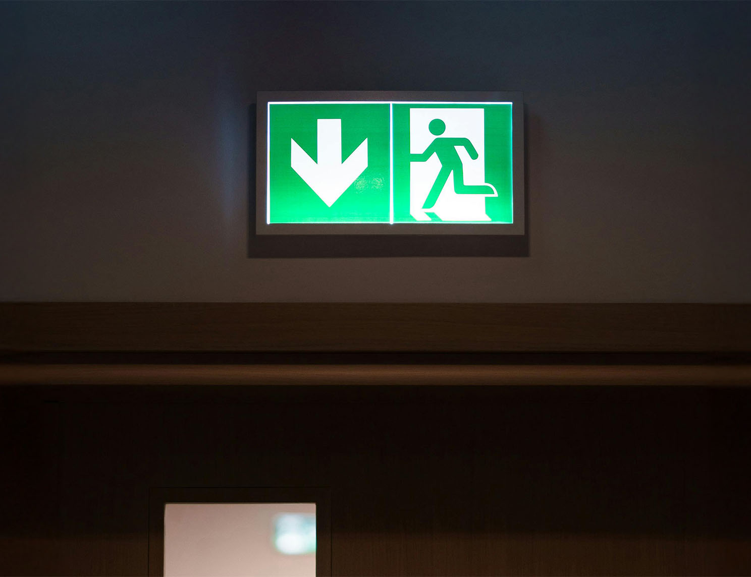 Fire exit symbol above door