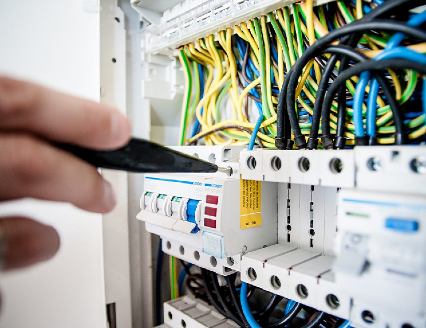 Electrician analysing fuse box