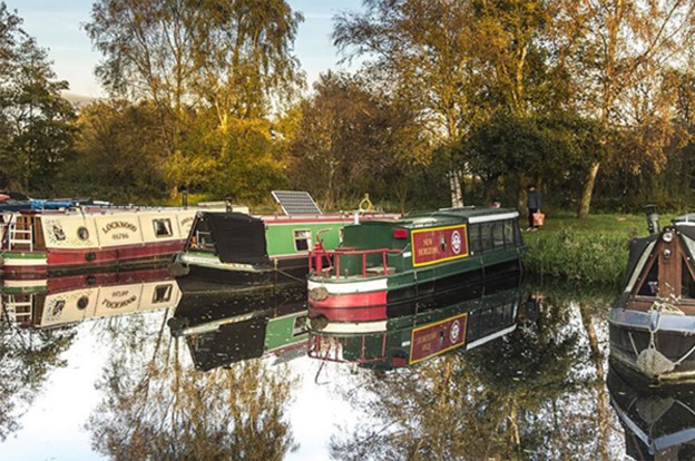 Boats docked alongside river