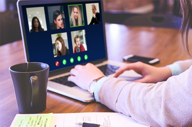 Employee on laptop having online meeting
