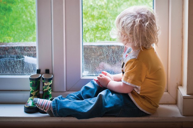 Child looking outside of window