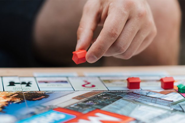 Person playing Monopoly board game