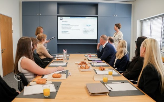 Gateway employees in meeting room presenting agendas