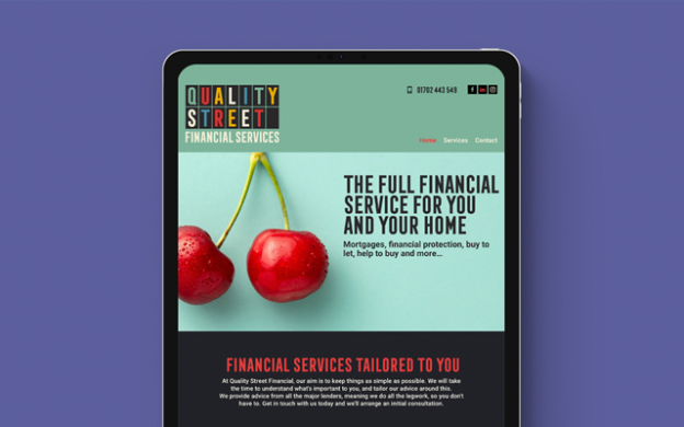 iPad tablet showcasing the Quality Financial Services website