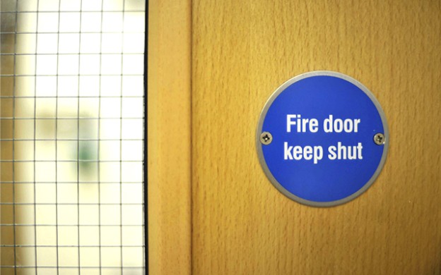 Fire door keep shut sign on door