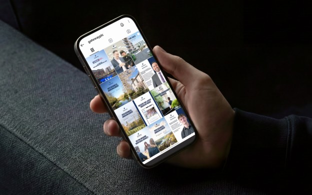 Person's hand holding mobile phone showing Gateway Instagram