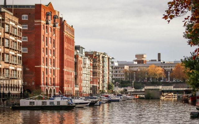 Building, offices and apartments alongside riverbank